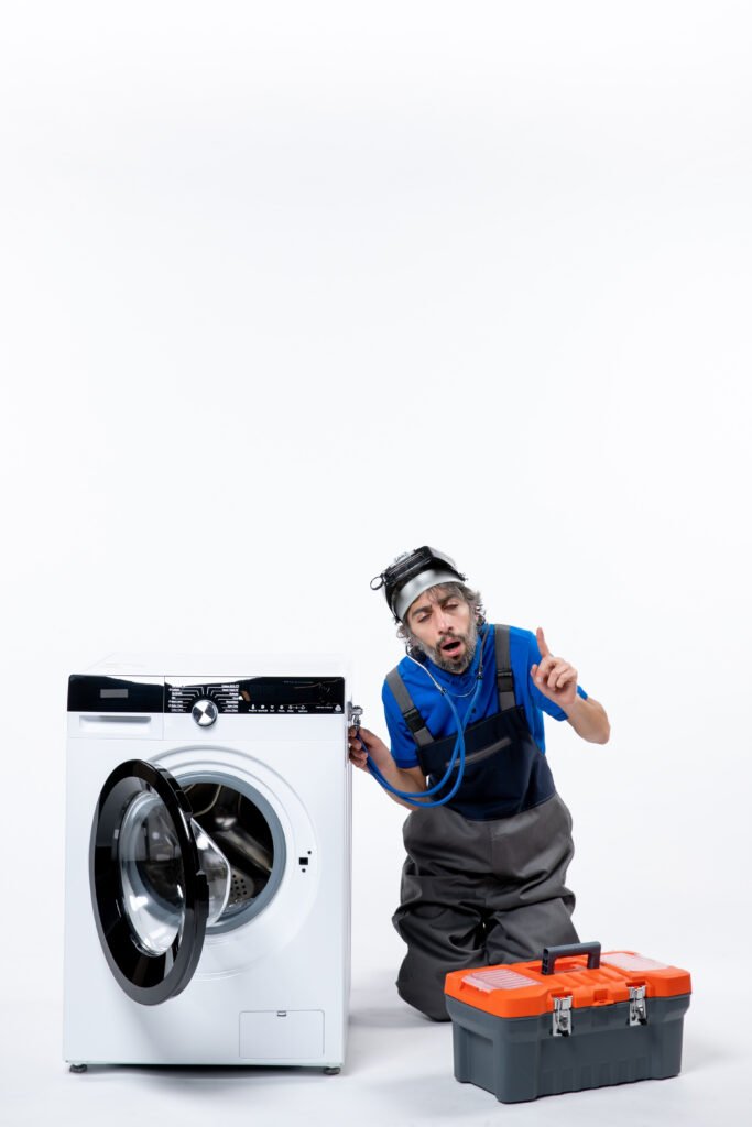 front view interested repairman with head lamp putting stethoscope washing machine white space